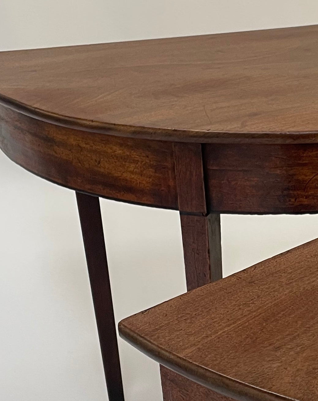 A matching pair of George III Mahogany Demi Lune tables.