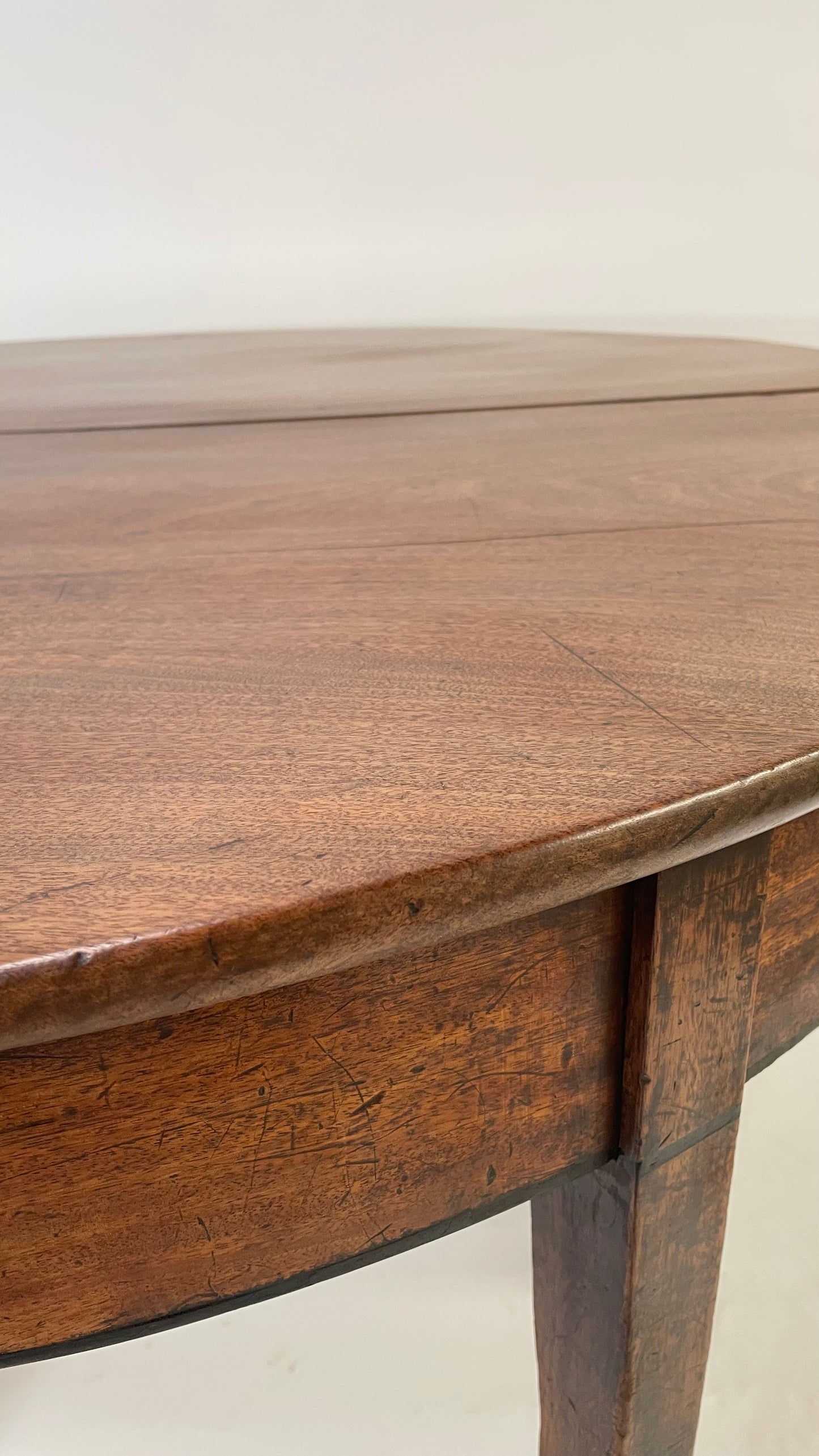 A matching pair of George III Mahogany Demi Lune tables.