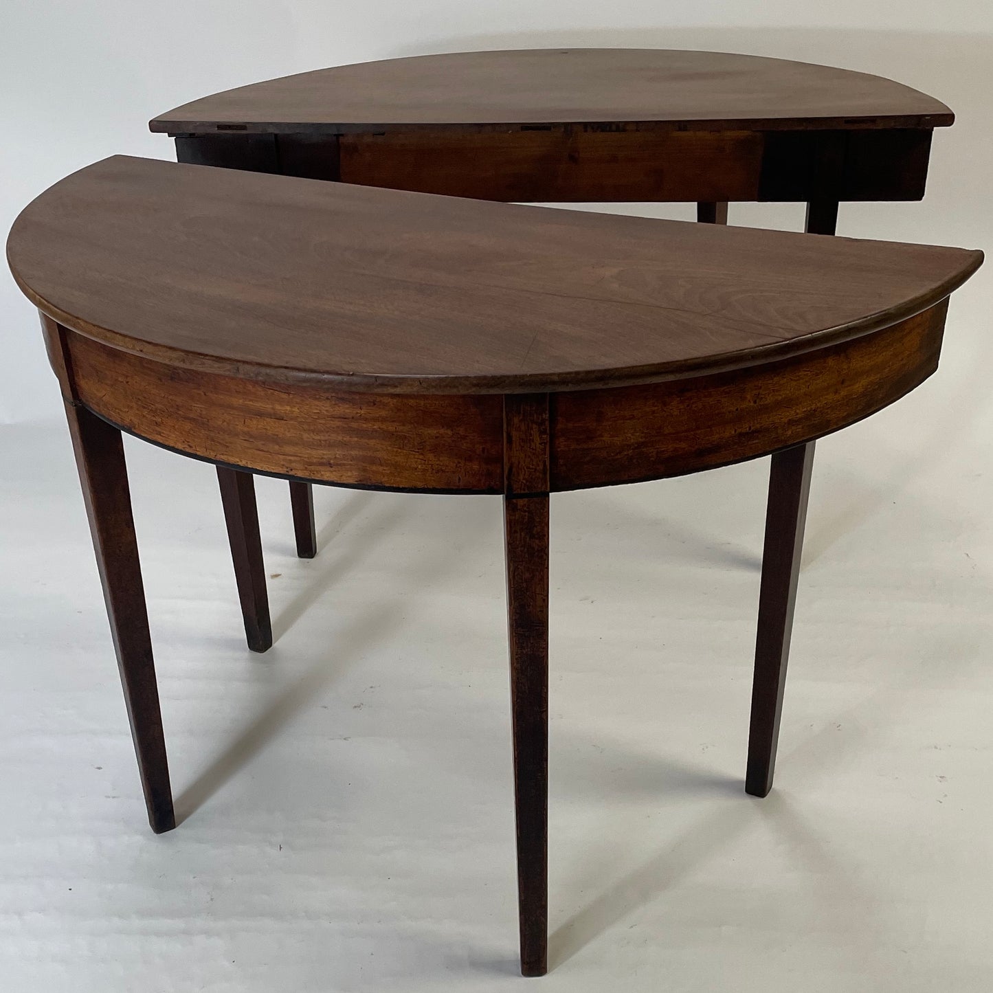 A matching pair of George III Mahogany Demi Lune tables.