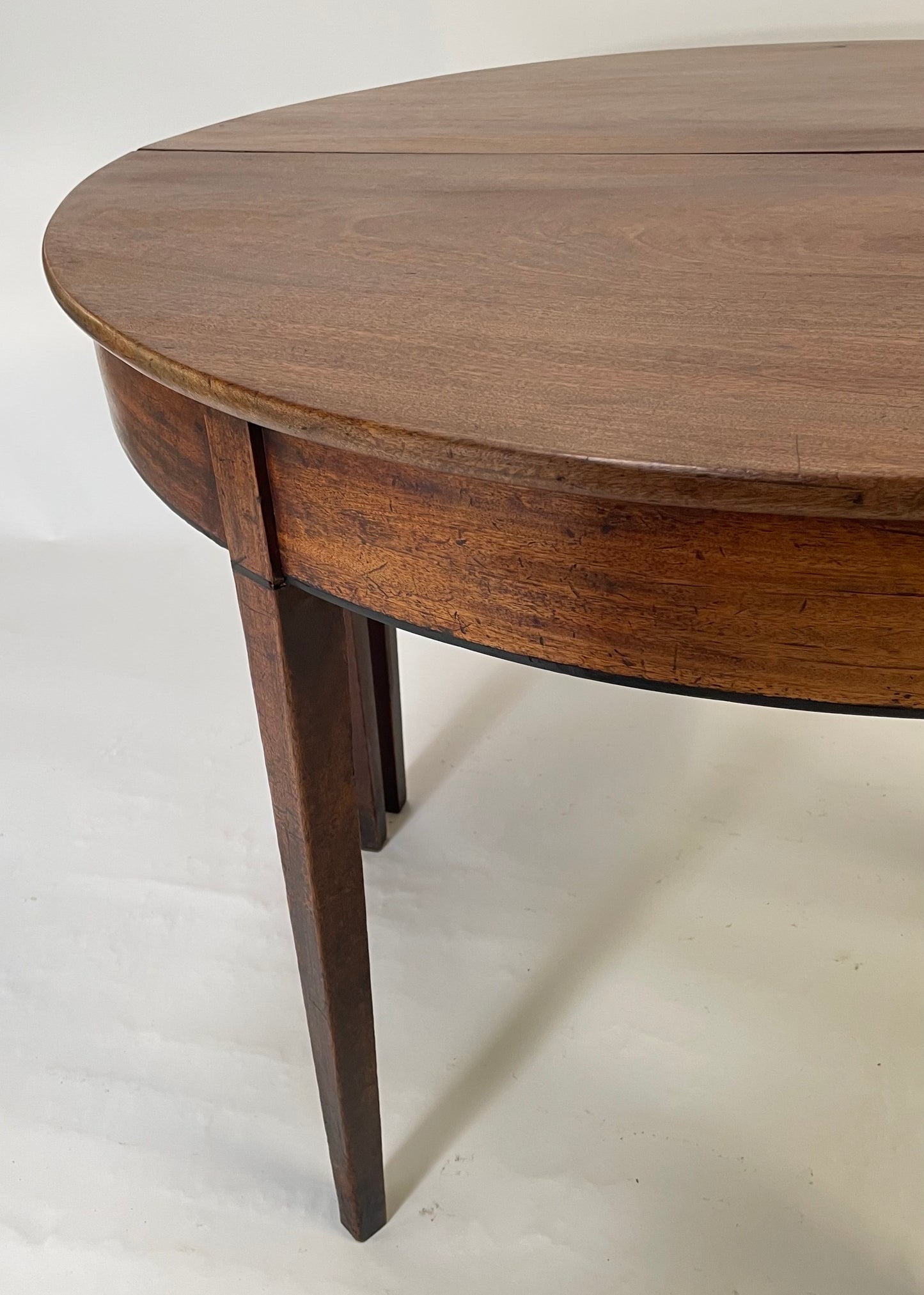 A matching pair of George III Mahogany Demi Lune tables.
