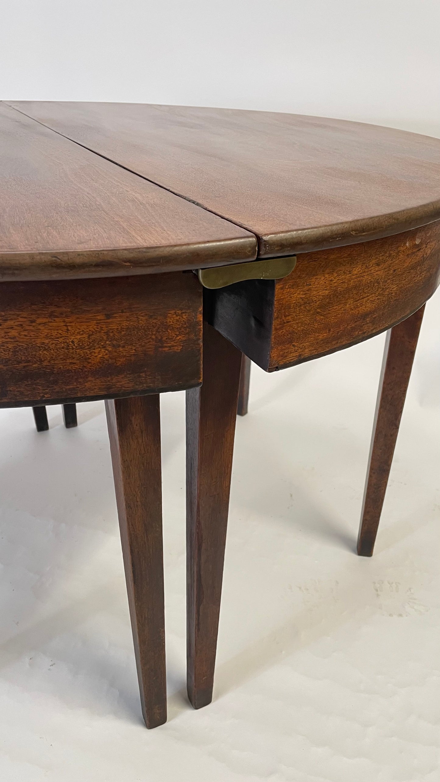 A matching pair of George III Mahogany Demi Lune tables.